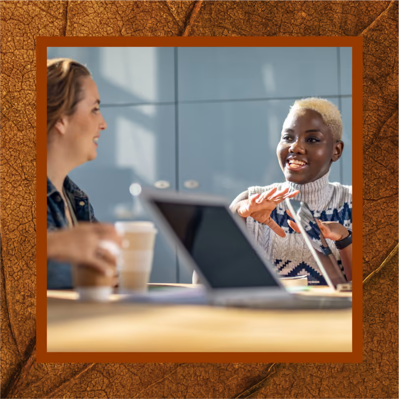 Two women in deep conversation at an office meeting