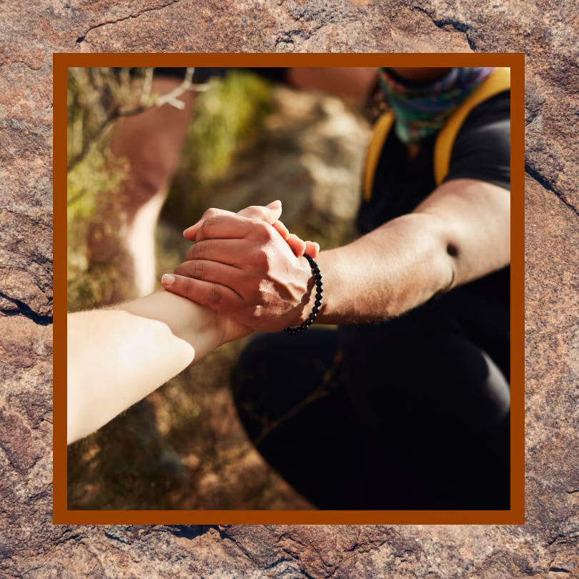 Someone grabbing a person's arm to help them up