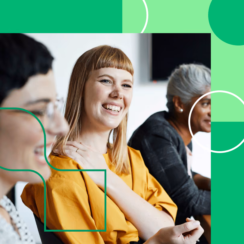 A woman smiles at her co-workers in a meeting