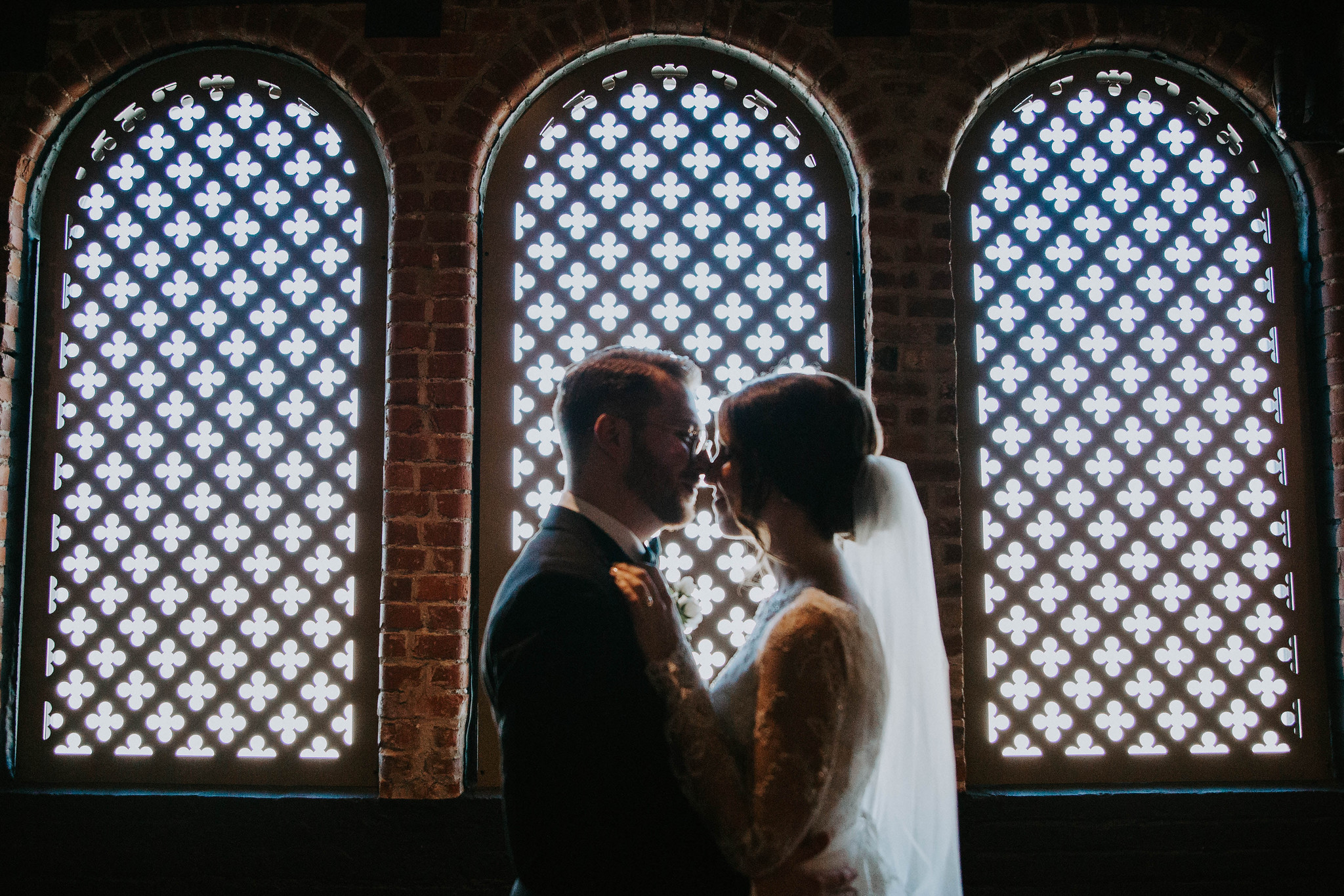 Couple standing in front of windows