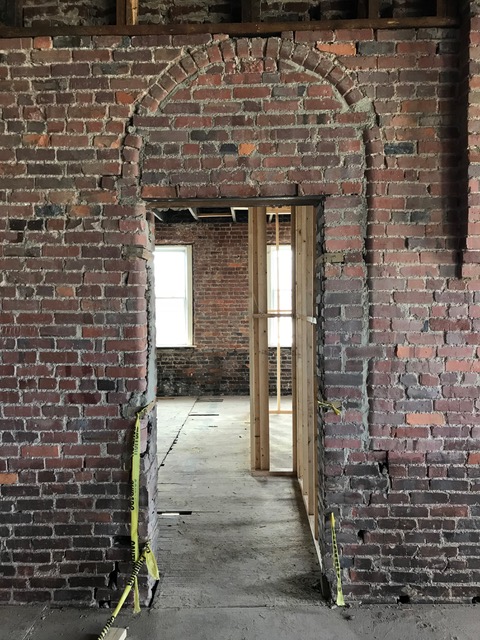 Arched window, now entry to restrooms