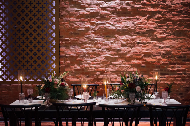 Dinner table against brick walls