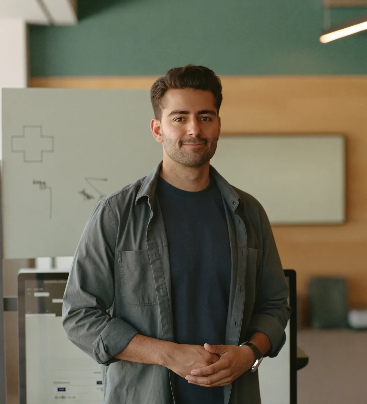 An AI startup founder standing in his tech company's office