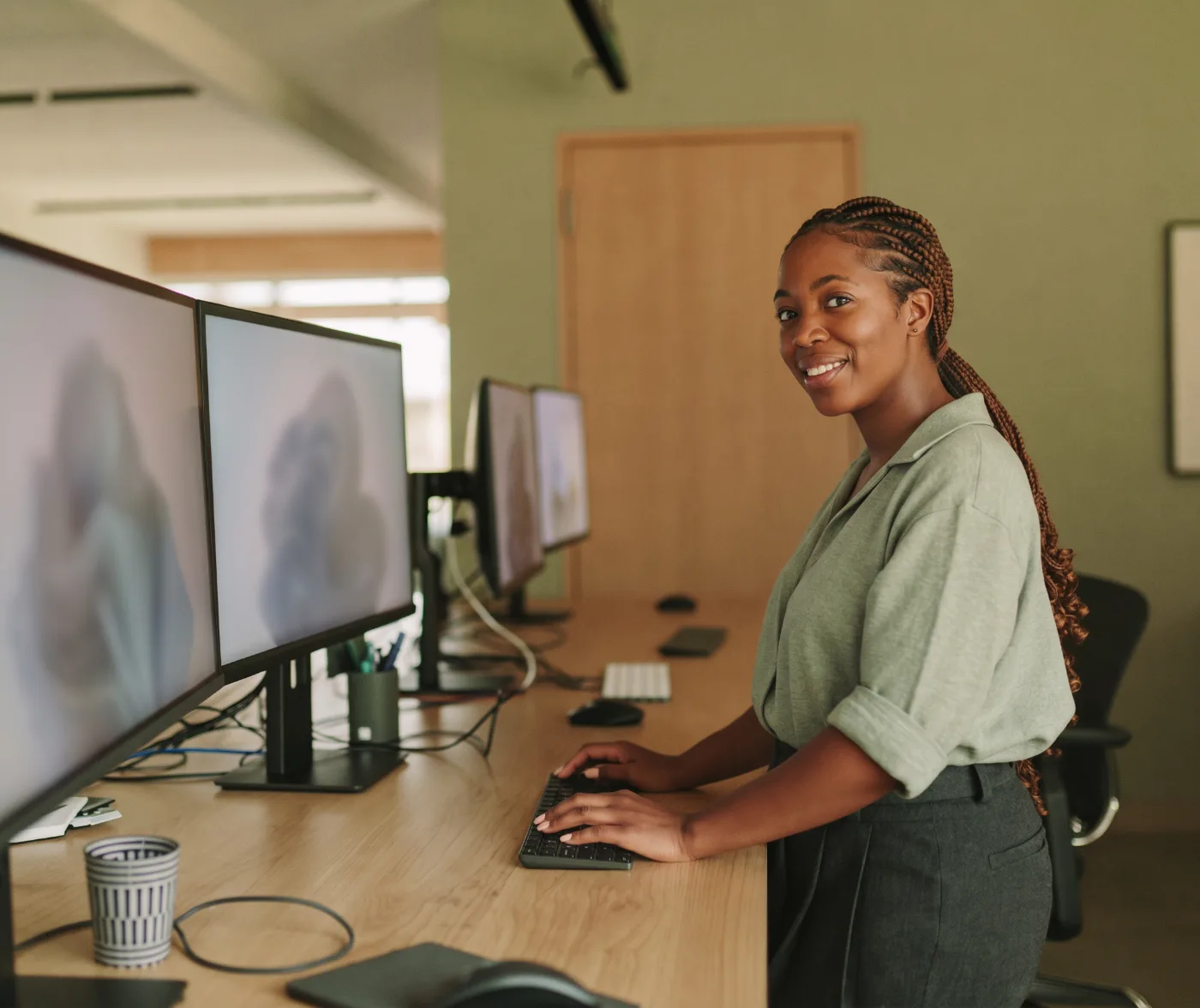 A tech company operations lead reviewing cloud spend at a standing desk
