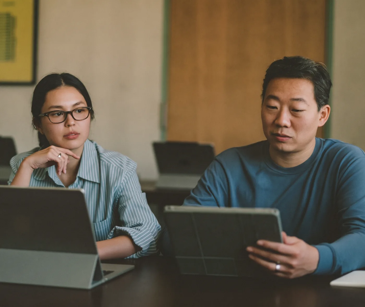 A tech company CEO and CFO discussing burn rate and runway over tablets