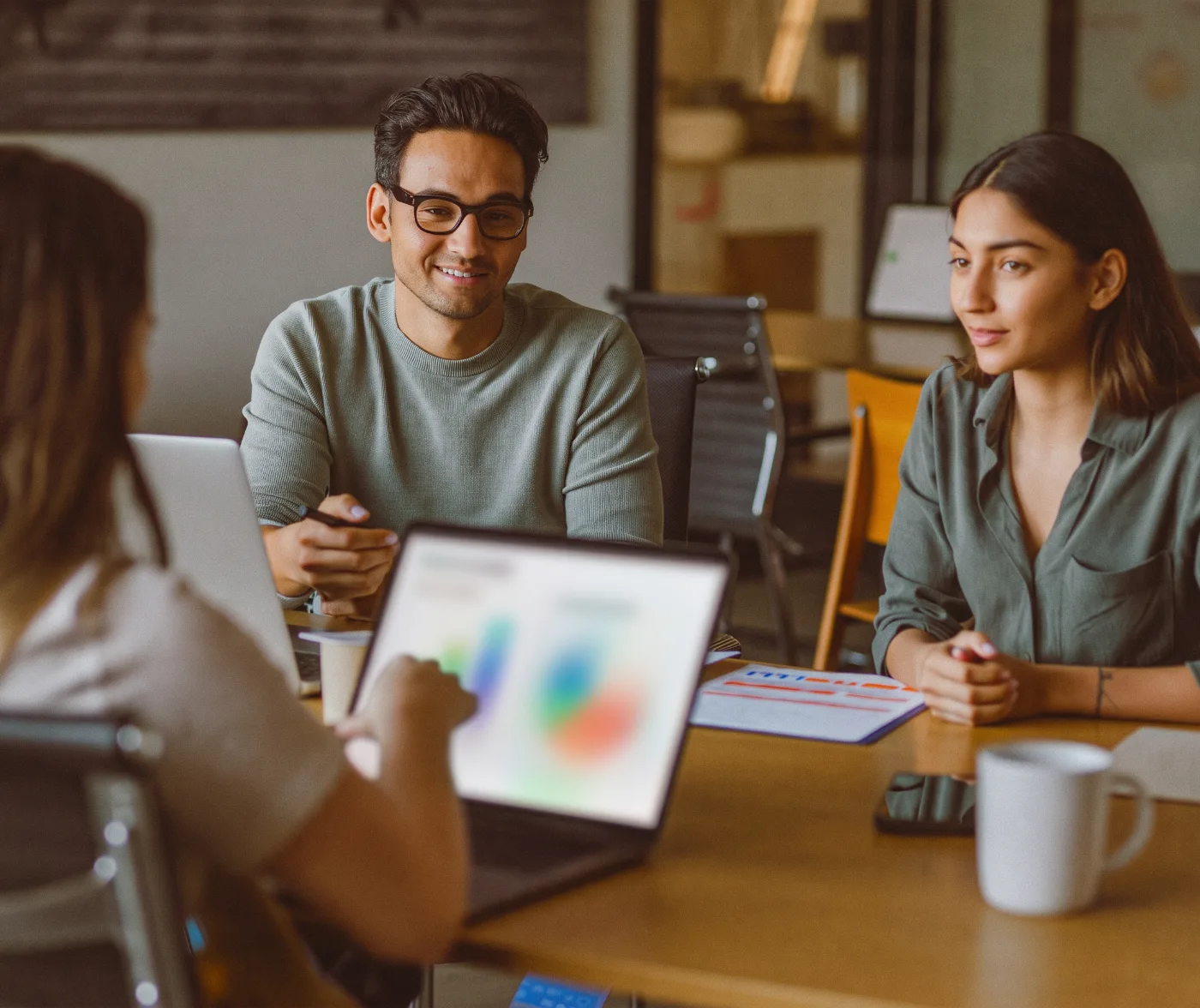 Two startup founders meeting with a finance advisor before a funding round