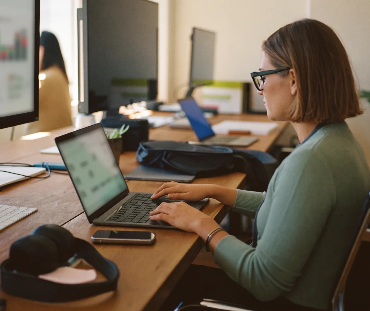 A startup cofounder reviewing bookkeeping on a laptop in a coworking space