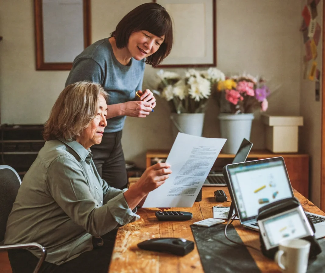 A flower shop owner and her business partner reviewing a report