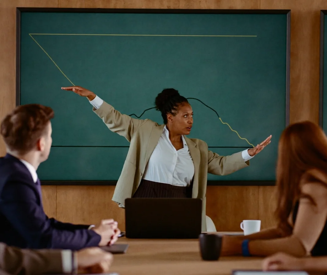 A finance leader presenting results to two executives