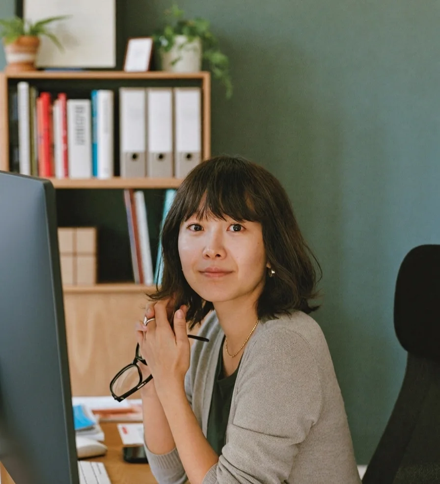 A CPA and firm partner at her desk in a calm accounting office