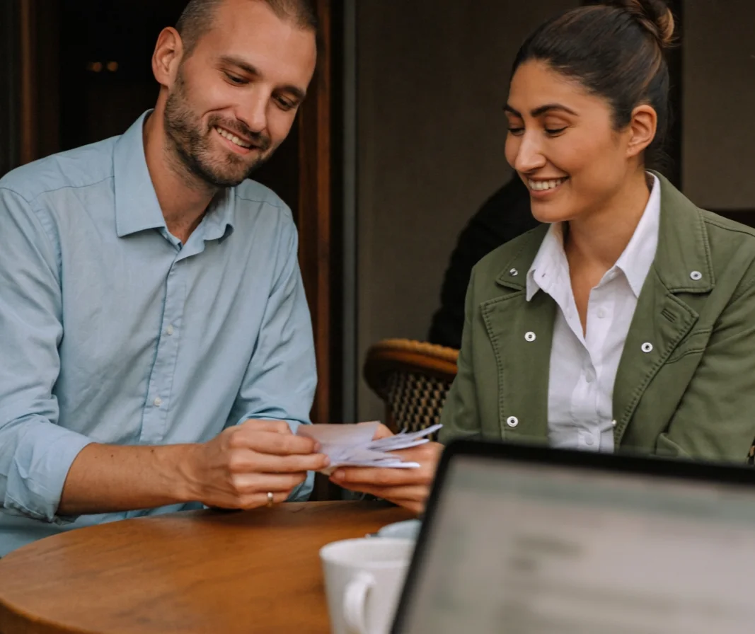 A bookkeeper sorting receipts with a small business client