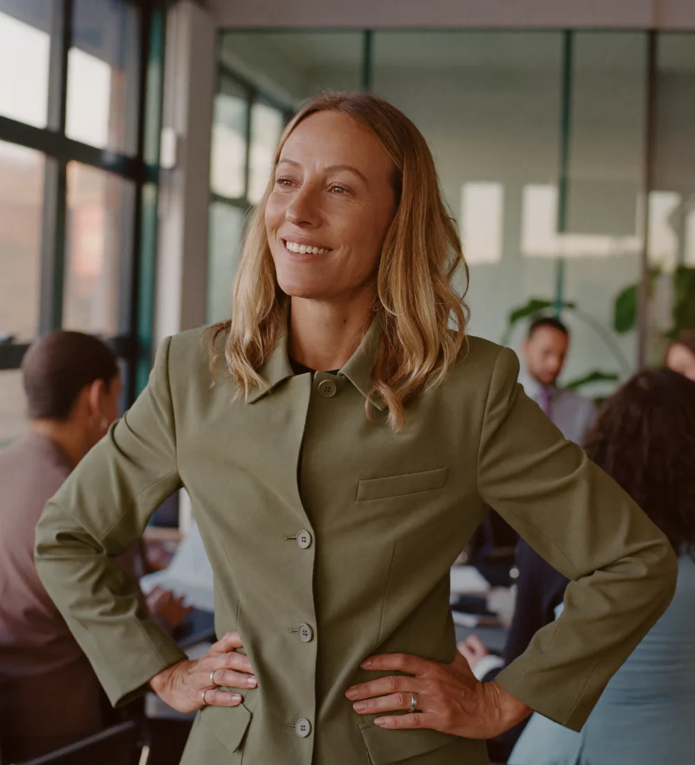 The managing partner of a consulting firm standing in a bright office
