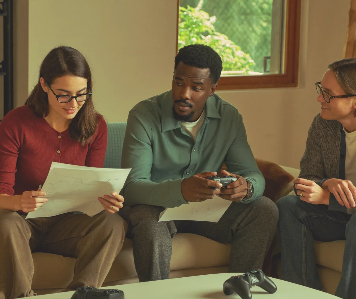 Two game studio cofounders reviewing their numbers with a finance advisor