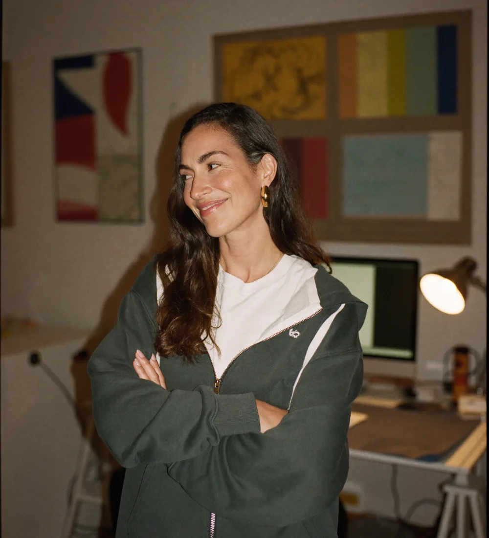 The founder of an independent video game studio standing in her studio