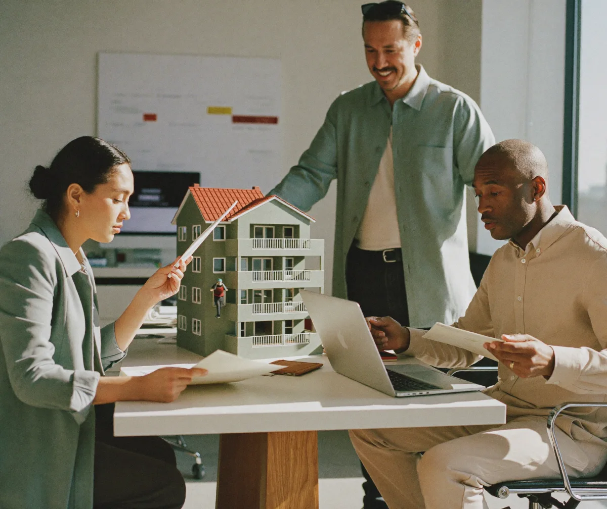 Two real estate partners reviewing their portfolio with a finance advisor