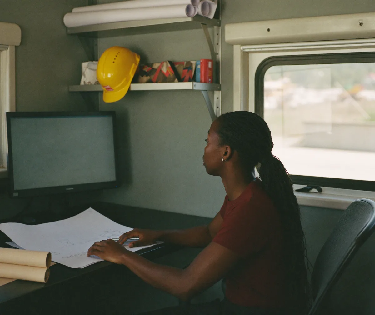 A project accountant working at her desk in a jobsite office