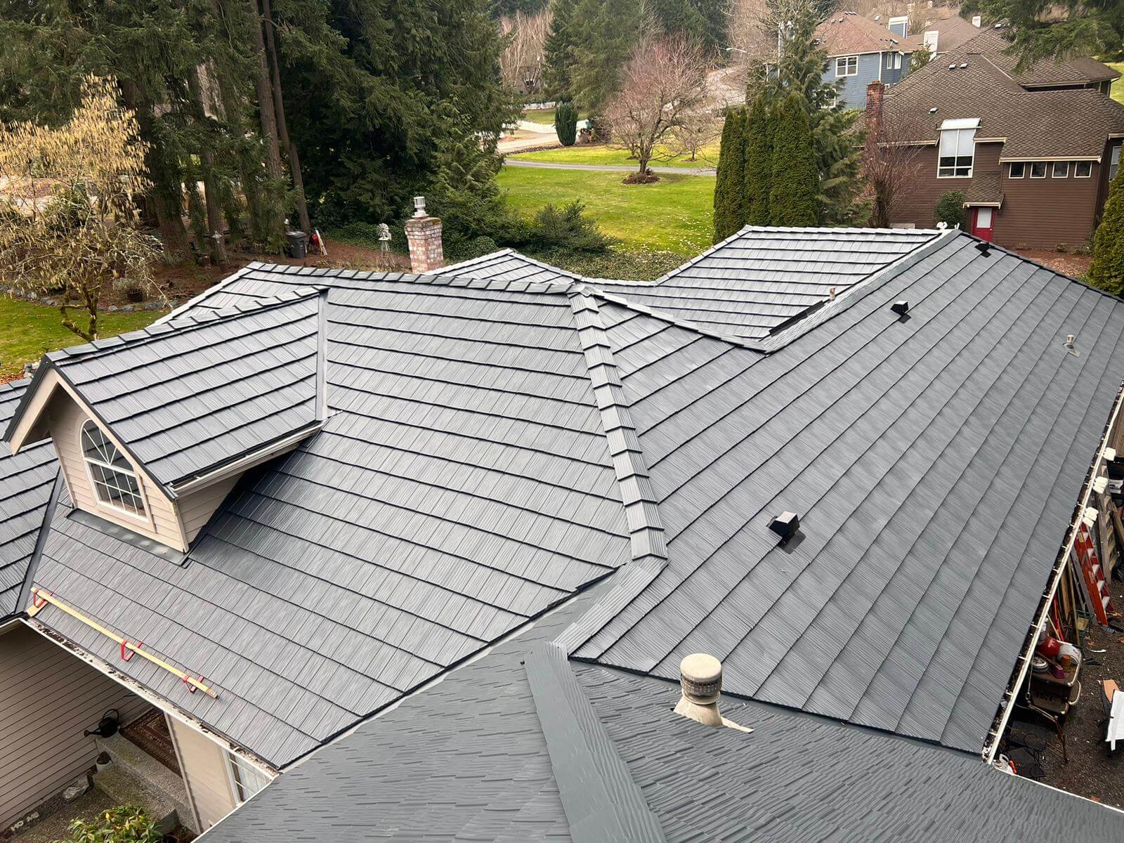 Metal roof styled as shake shingles, installed on a home