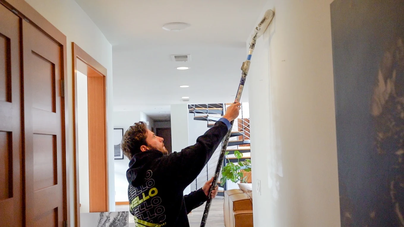 Professional painting a wall with enamel paint for lasting results