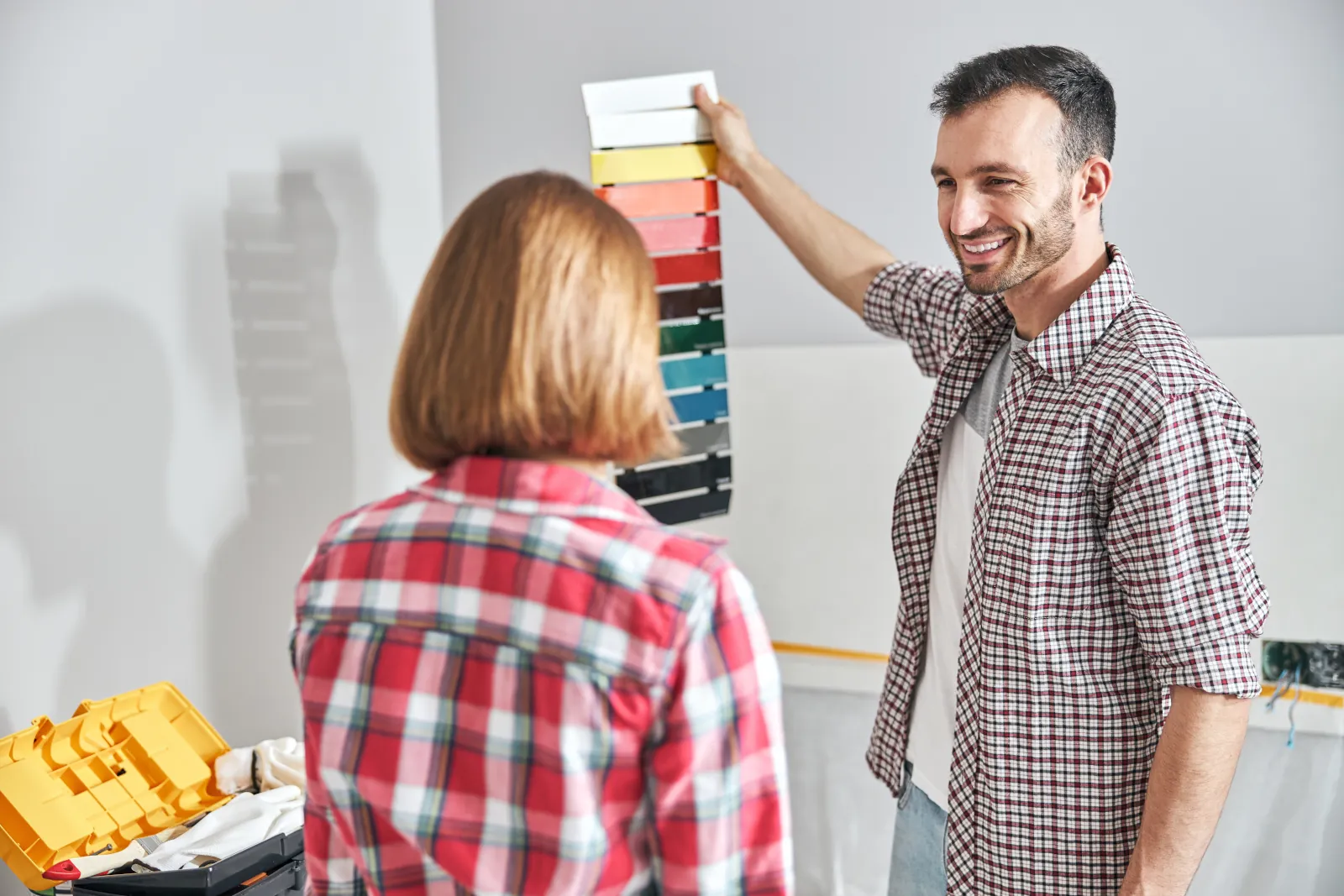 A painting contractor showing a homeowner color options for interior home painting