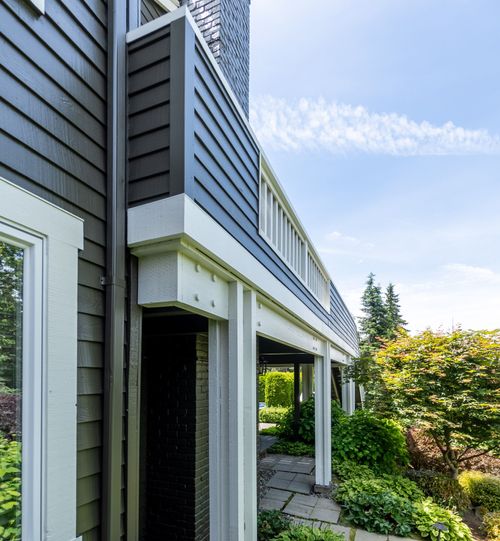 Two-story residential repaint with stone and siding