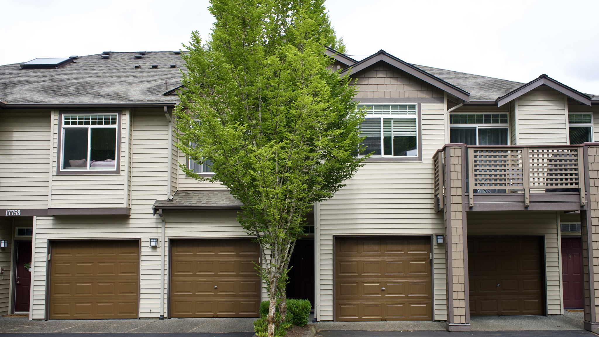 Townhouse exterior with newly painted siding, trim, and garage doors in a residential community

