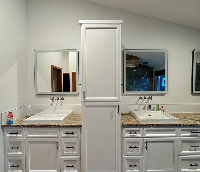 After interior painting: bathroom transformed with freshly painted white cabinets, trim, and walls, creating a brighter and more modern space
