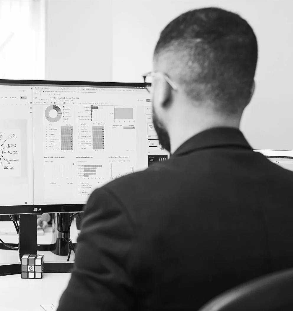 Man looking at analytics dashboard on computer screen