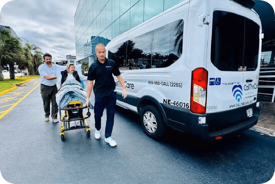 Image of a man pushing a stretcher (gurney) next to a van, which describes a non-emergency stretcher transportation service