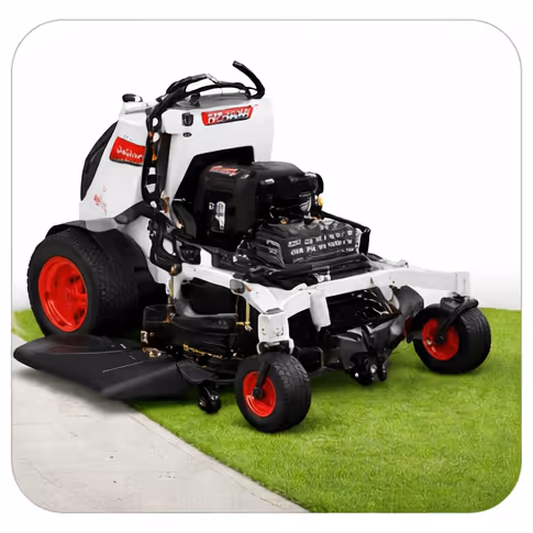White and black zero-turn lawn mower with red wheels parked on green grass next to a concrete path.
