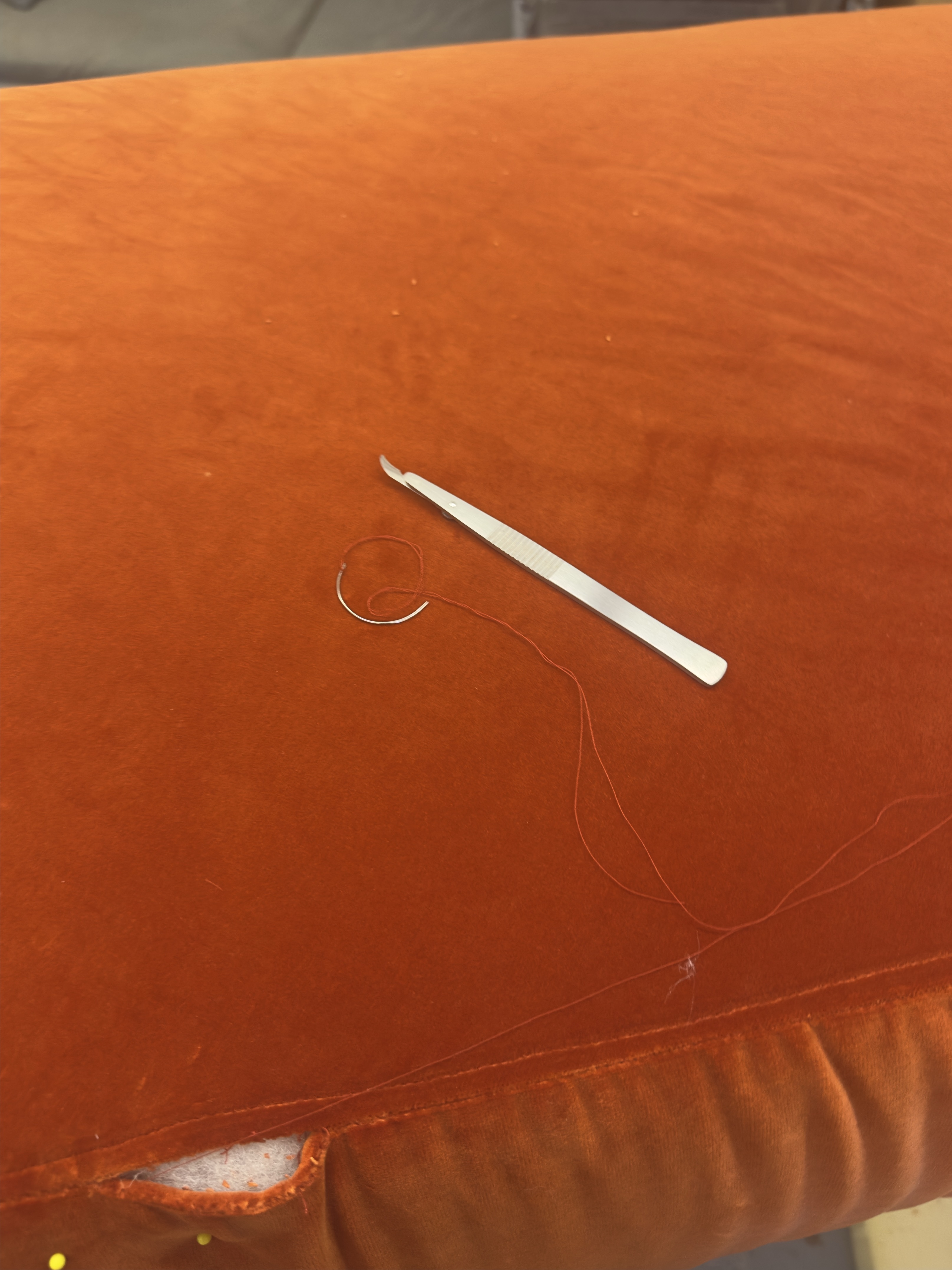 Model Crossed Arms wearing denim bra top and demin and white pleather pants with chains