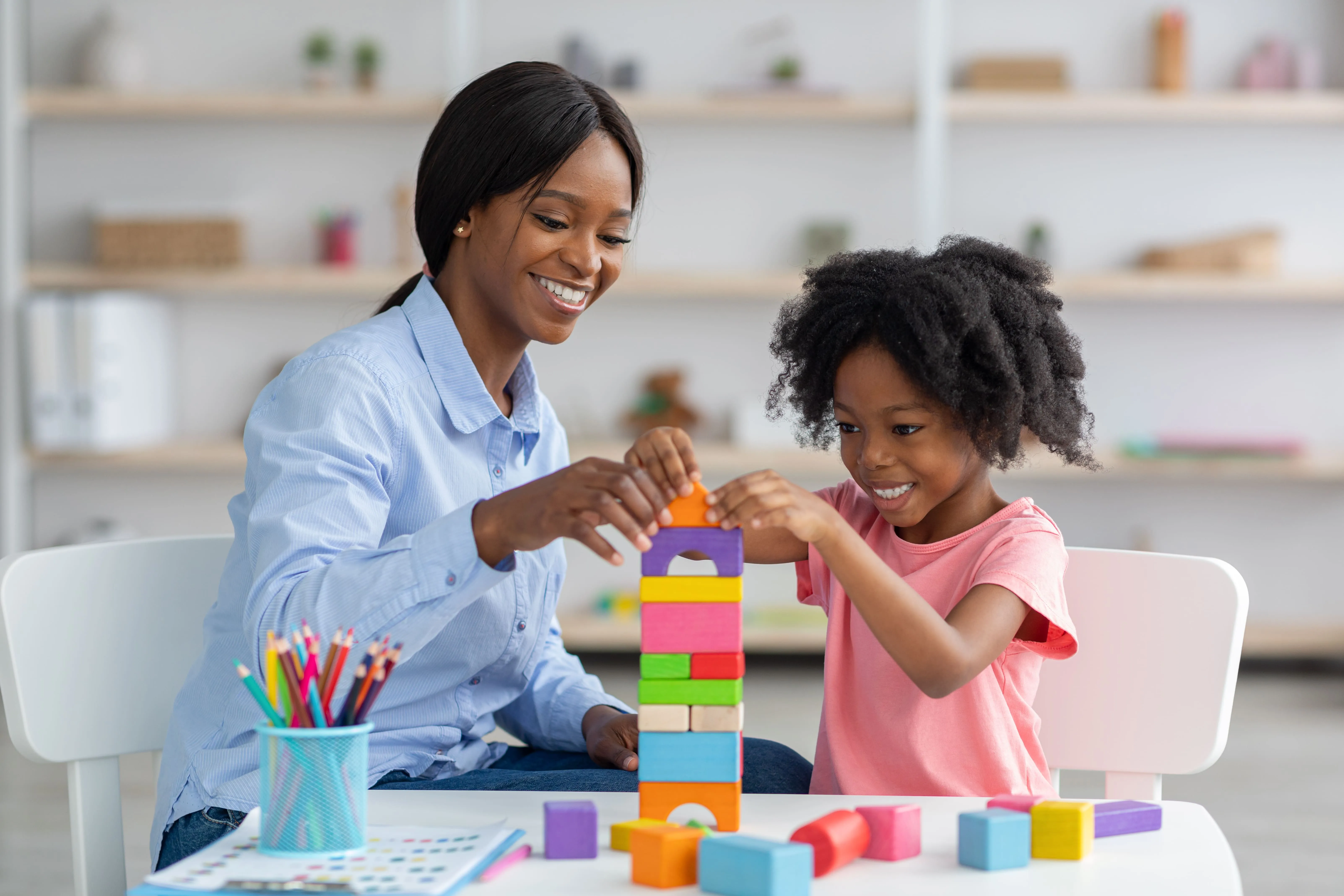 A woman and child playing with blocks.