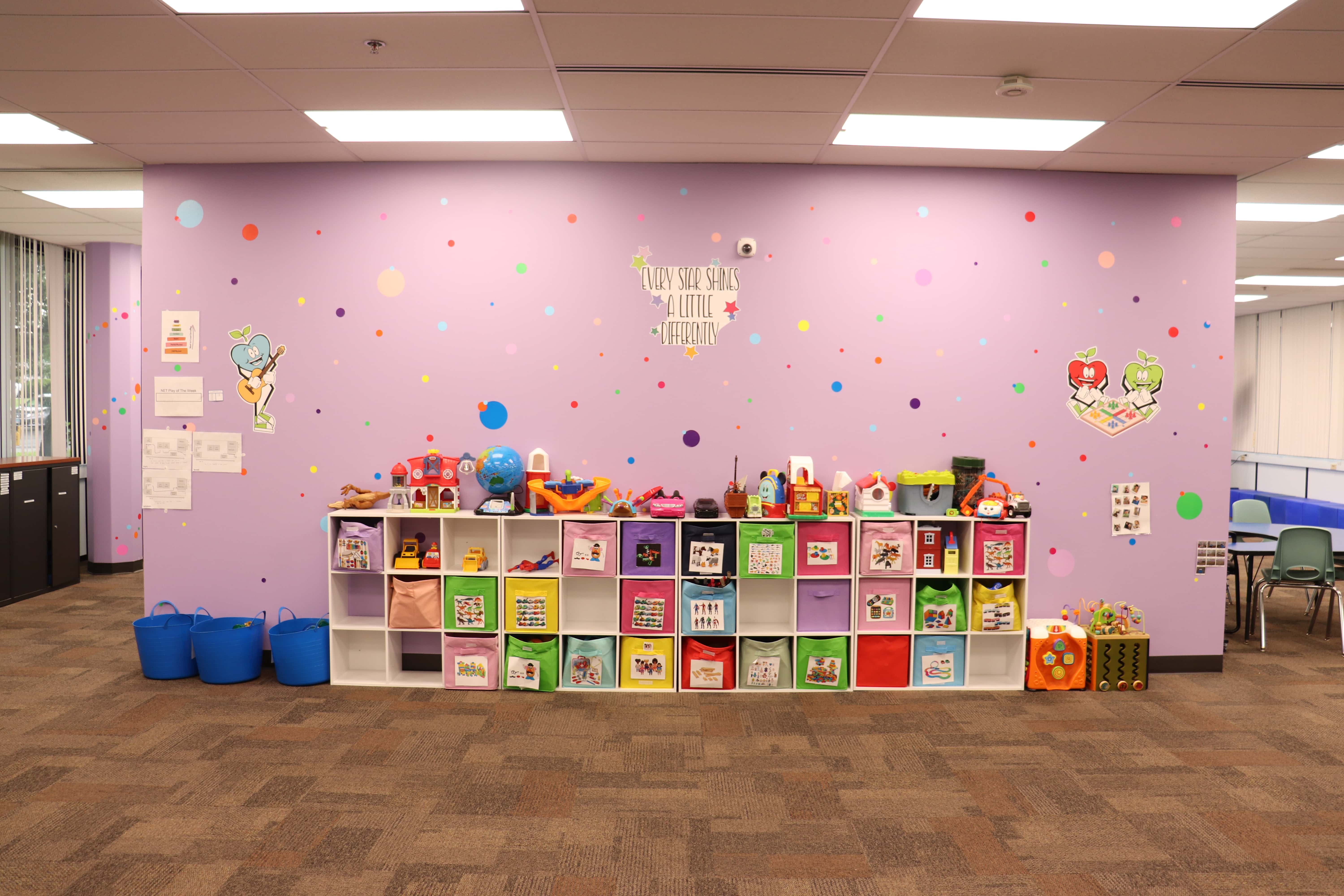 Crystal Lake ABA Clinic toy and puzzle wall for autistic children.