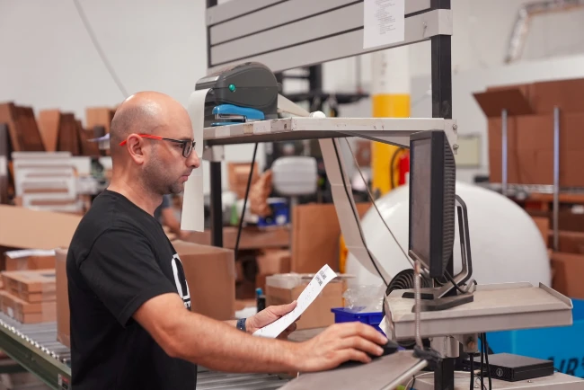Staff member working on 3pl service by getting ecommerce order ready