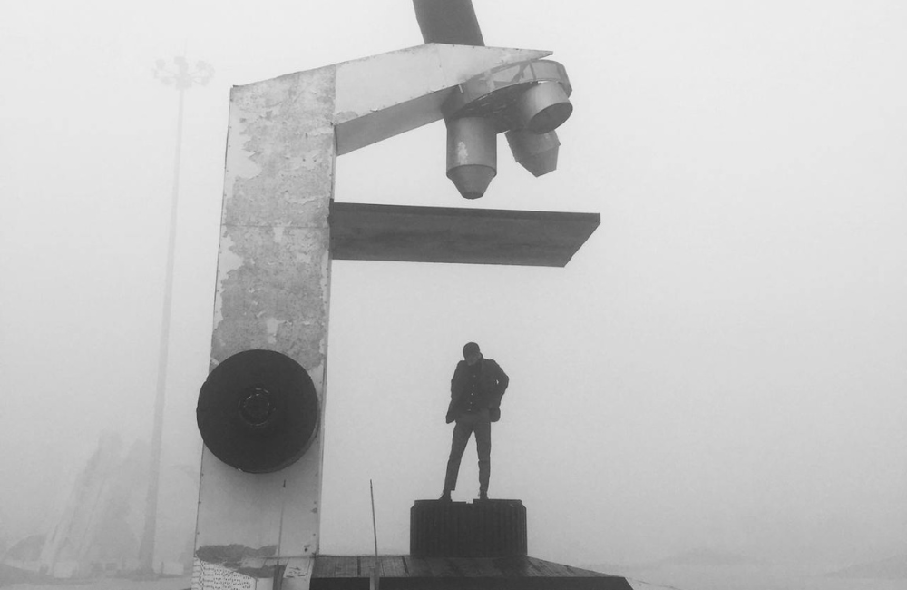 A man standing underneath a microscope.
