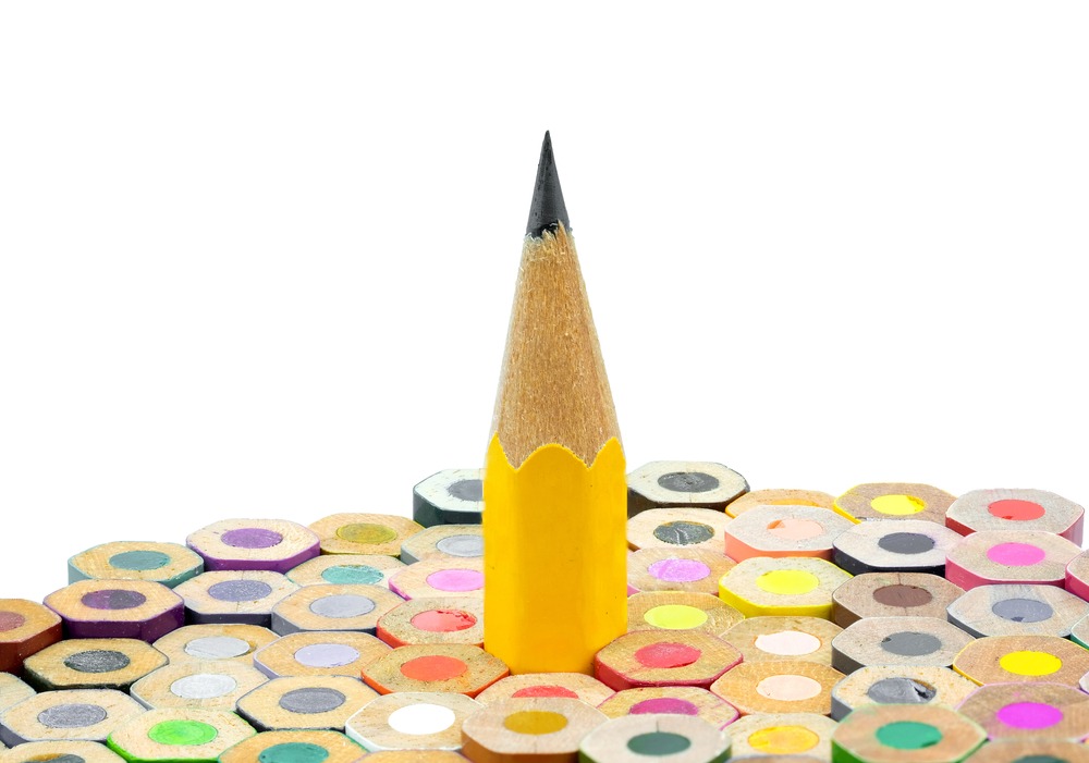 A pencil standing the opposite way up among other coloured pencils.
