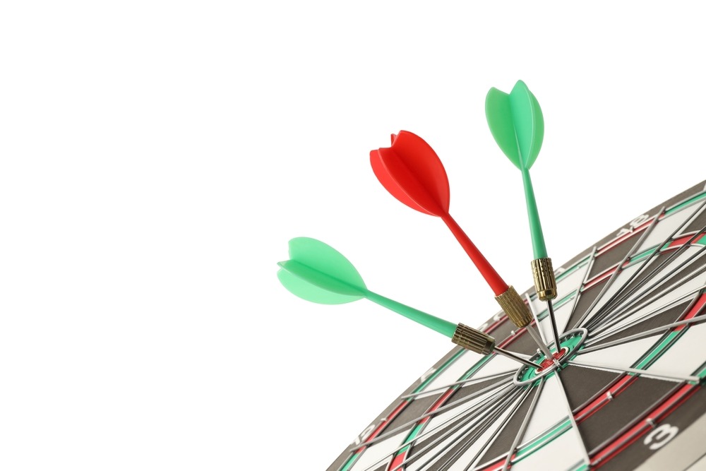 Three darts hitting the bullseye on a dart board as representation of the importance of retargeting strategies that hit the right target audience.