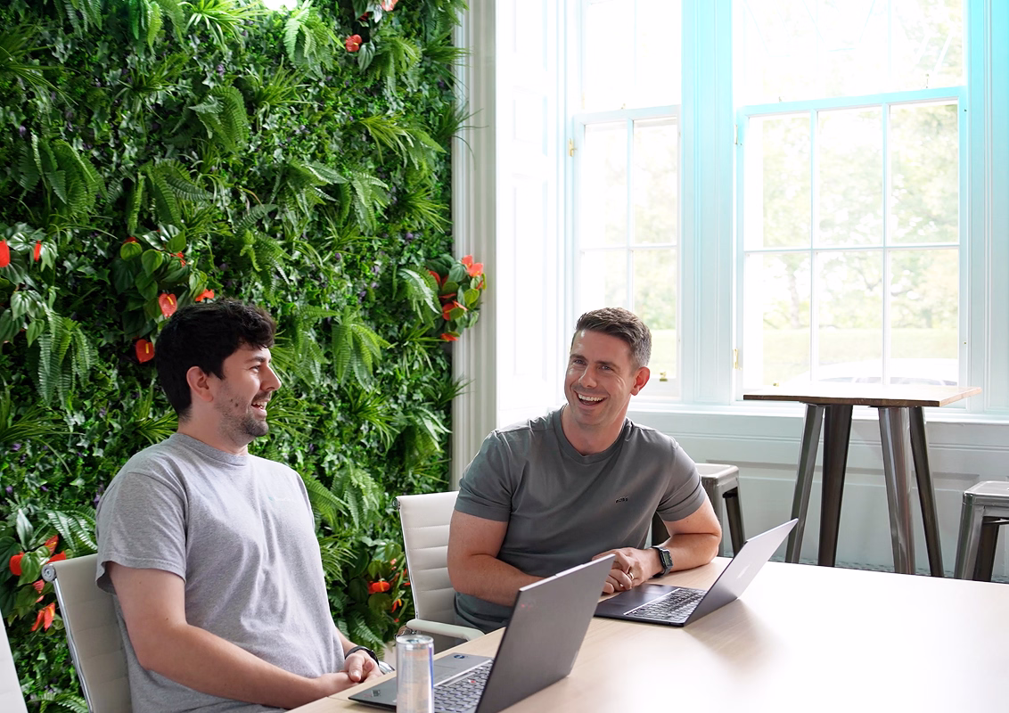 ClearSky Logic team members collaborating in a relaxed meeting room