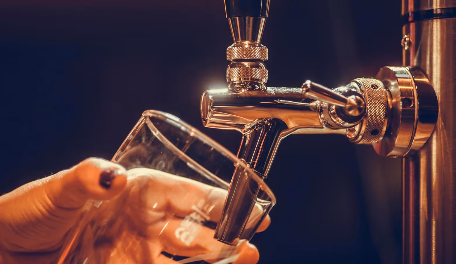 Beer being poured from a tap into a glass
