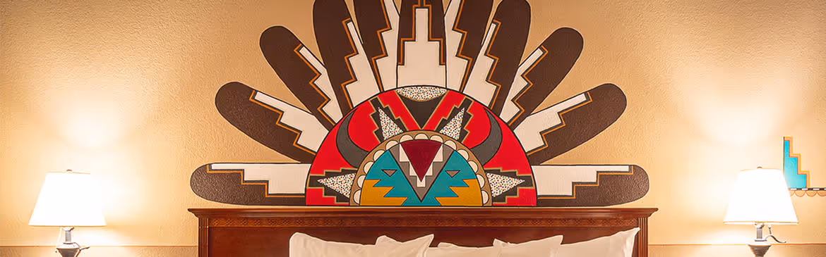 Colorful Artist guestroom with mural on the wall with king bed with white bedding