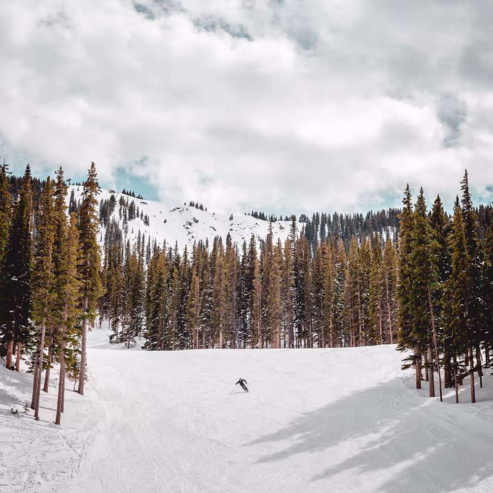 A mountain with snow with person skiing