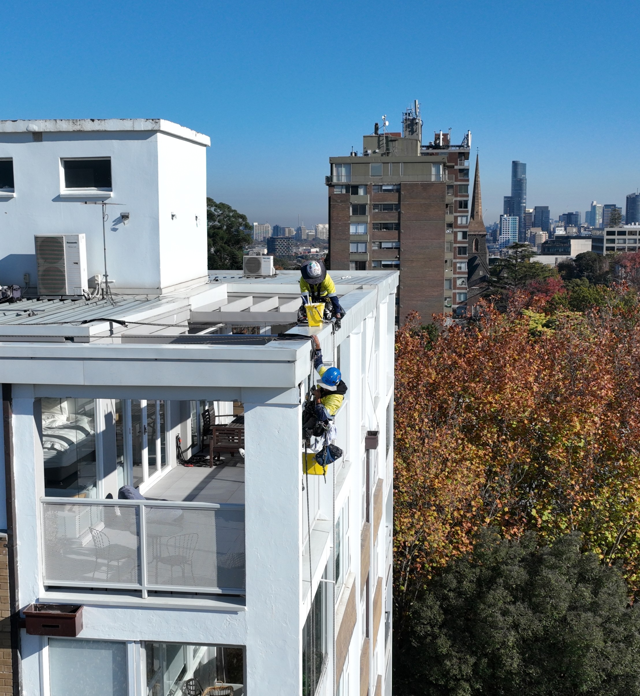 A worker in a boom lift for Avello Group painting project