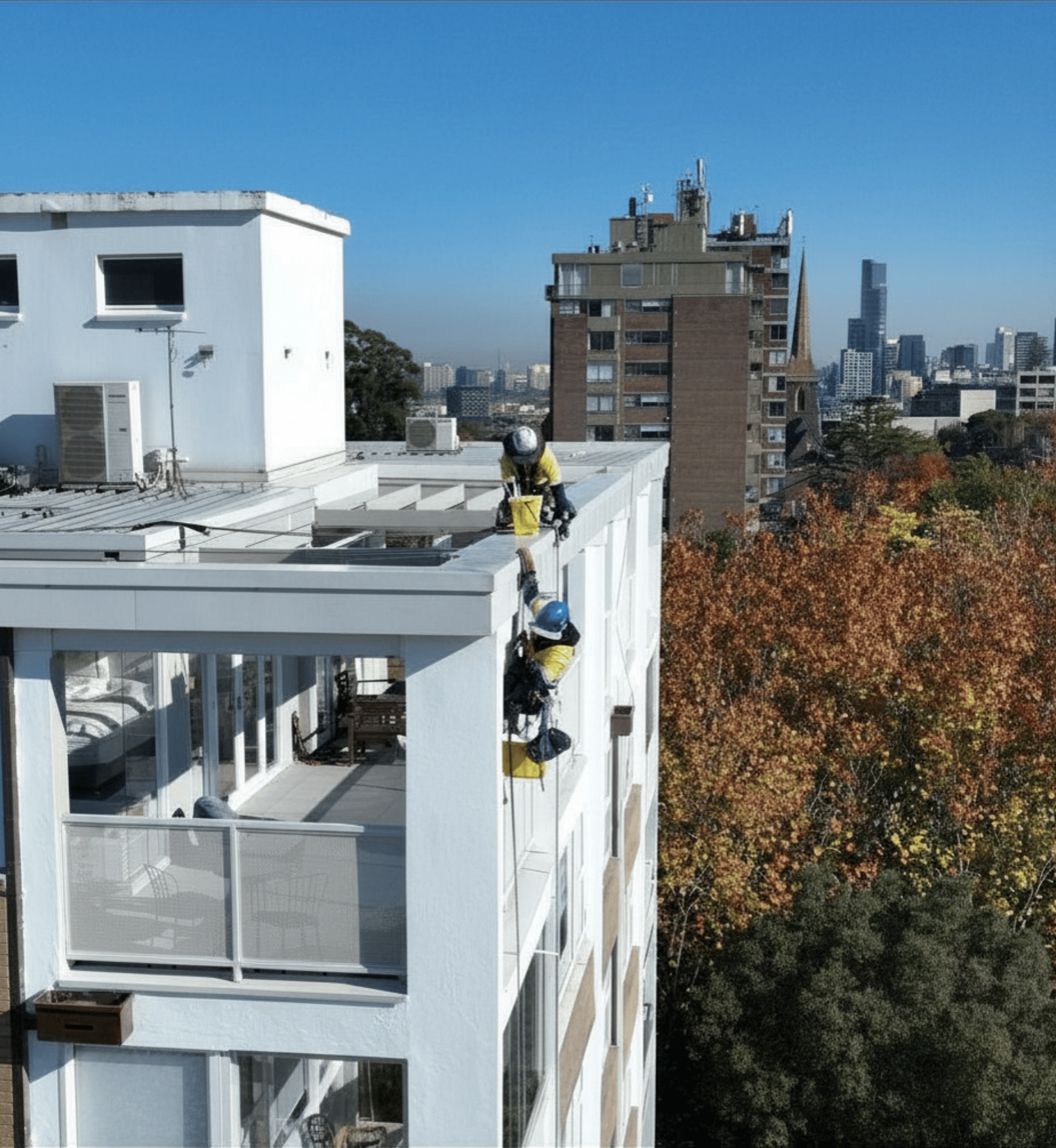 A worker in a boom lift for Avello Group painting project