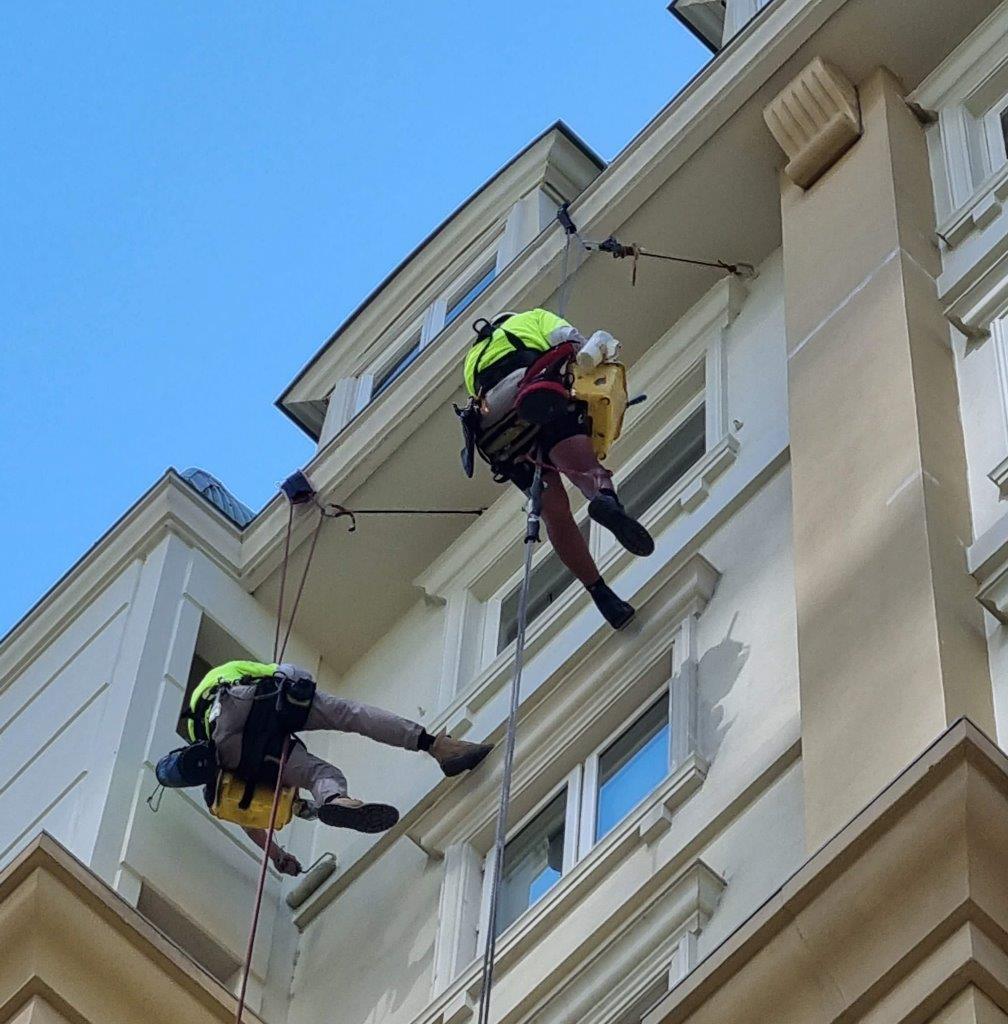 IRATA rope access painters repainting a high-rise facade in St Kilda.