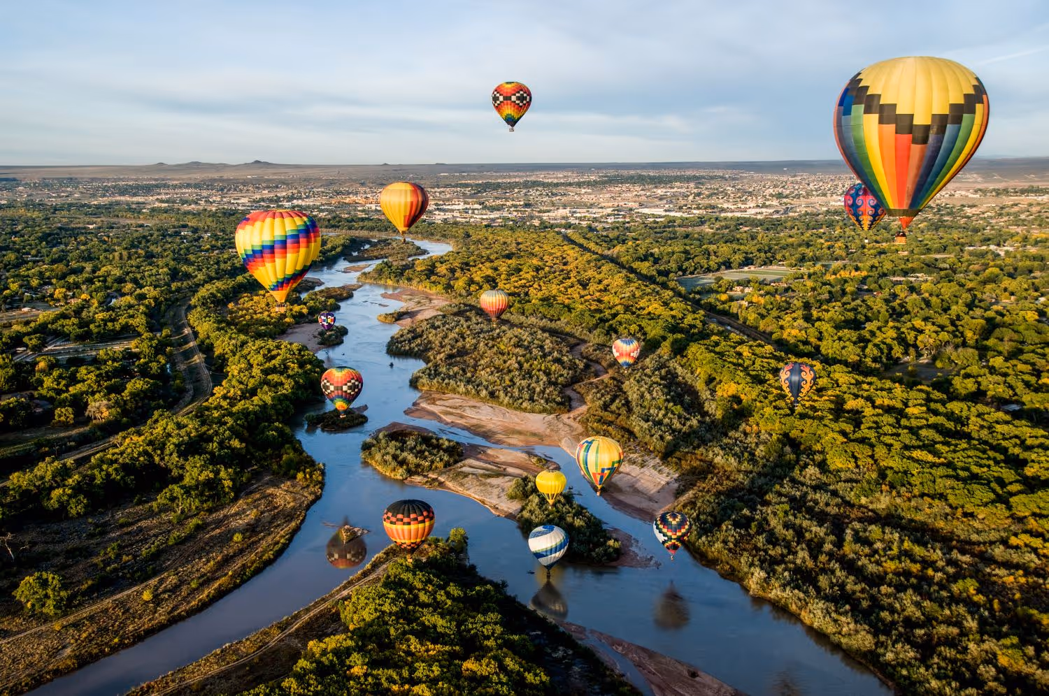 Hot air balloons in flight over the Rio Grande river