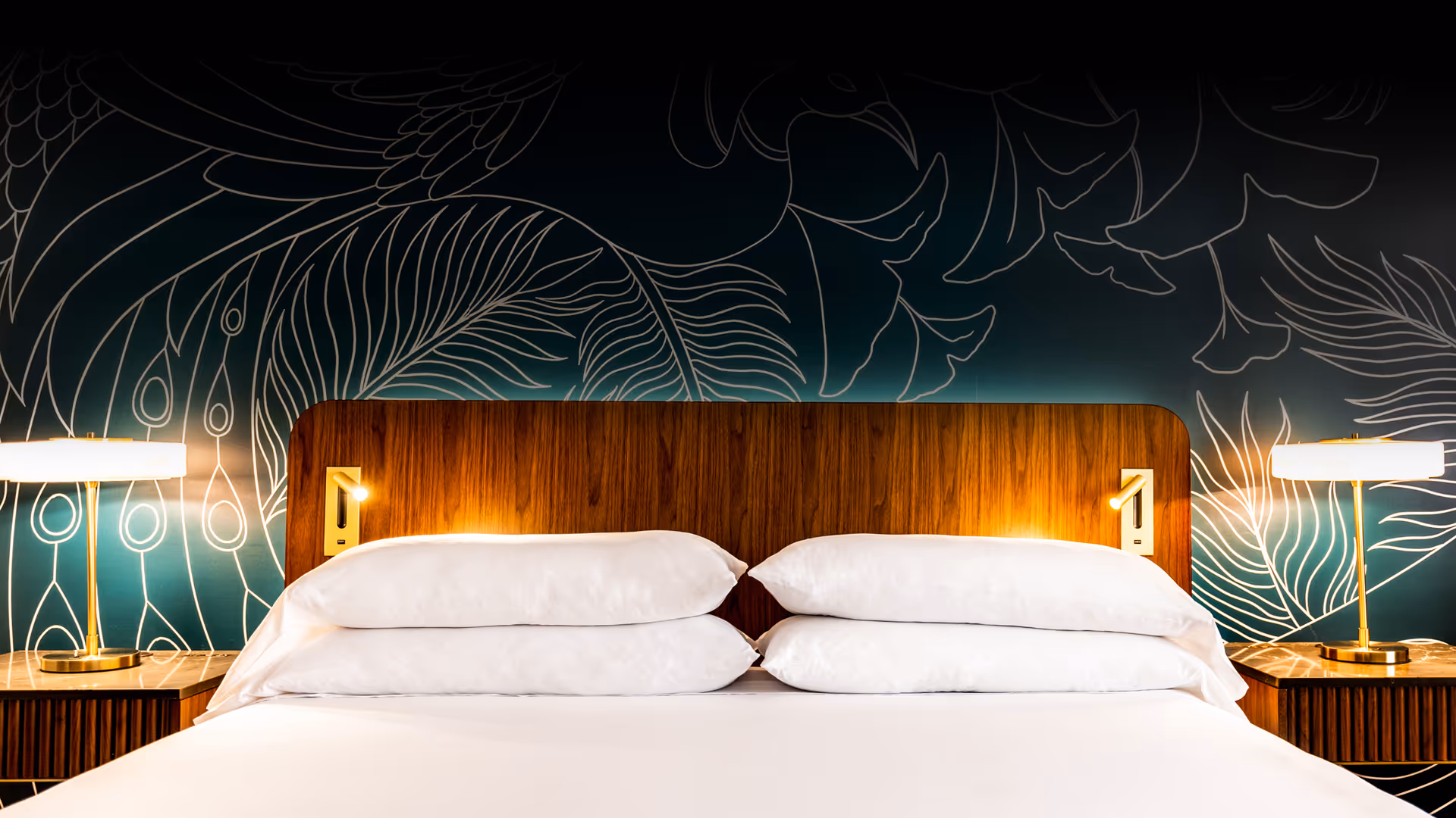 King room with green wallpaper with print of bird