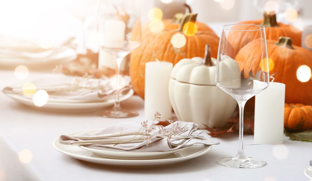 Table setting with pumpkins and white plates