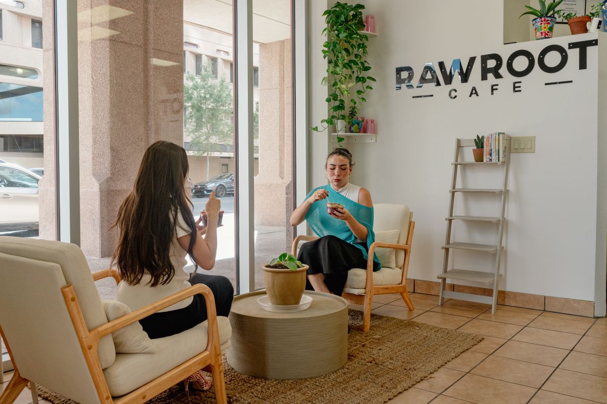 Interior of Rawroot Smoothies with two ladies eating acai bowls