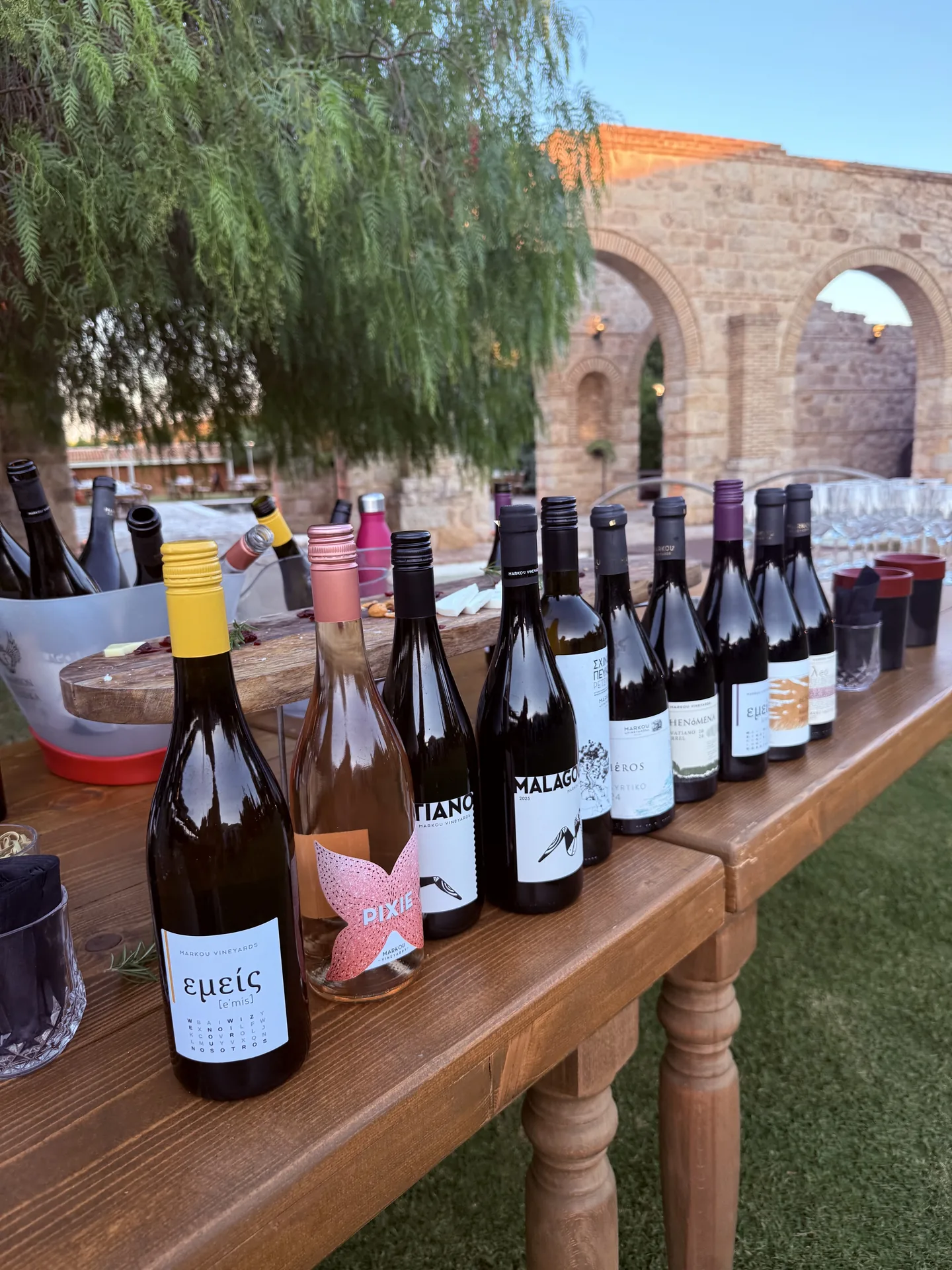 A wine tasting laid out at the Entrepreneur First closing dinner beside an ancient stone arch