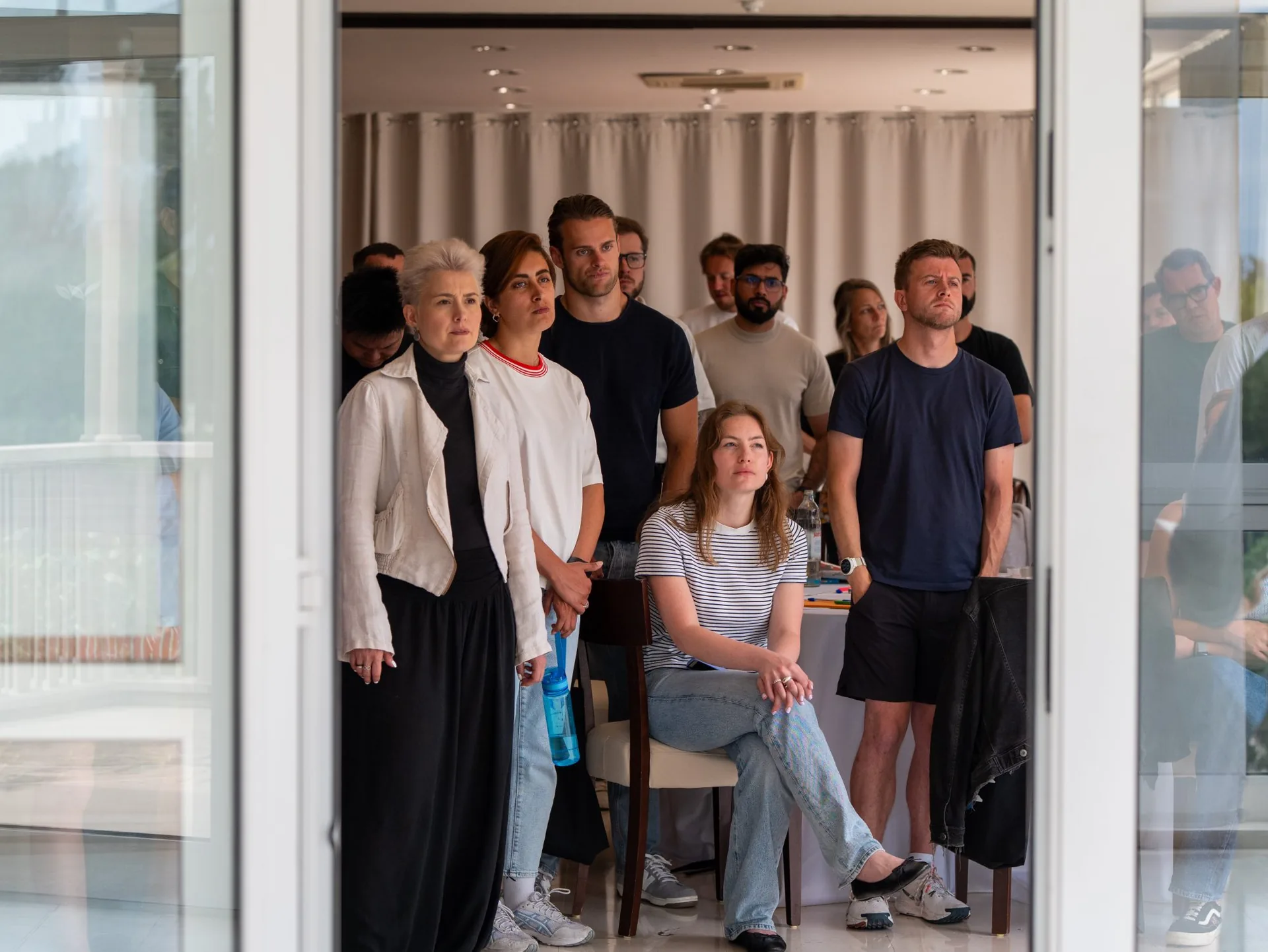 A team listening in a workshop session at a villa