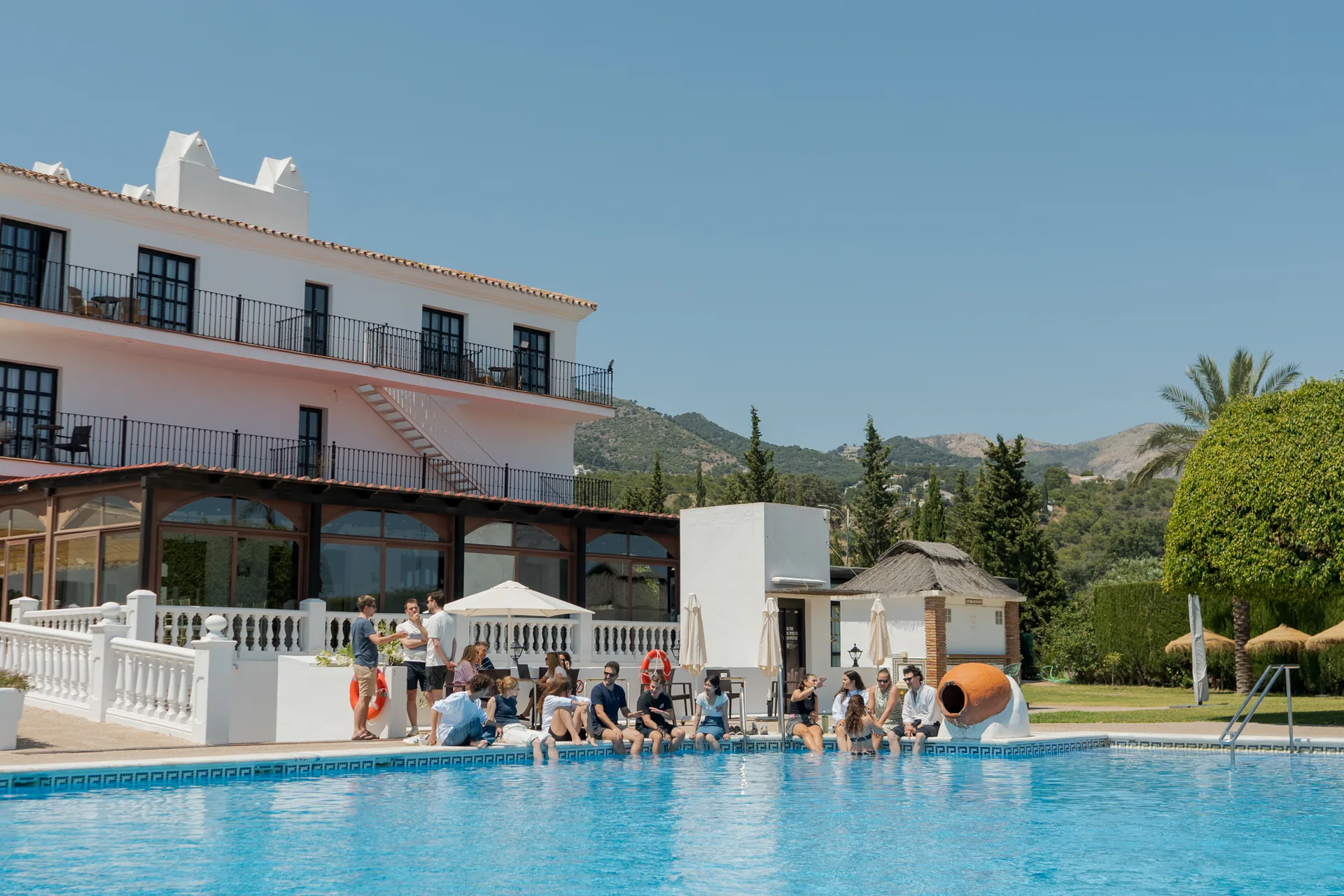 A team by the pool at a hillside hotel near Málaga
